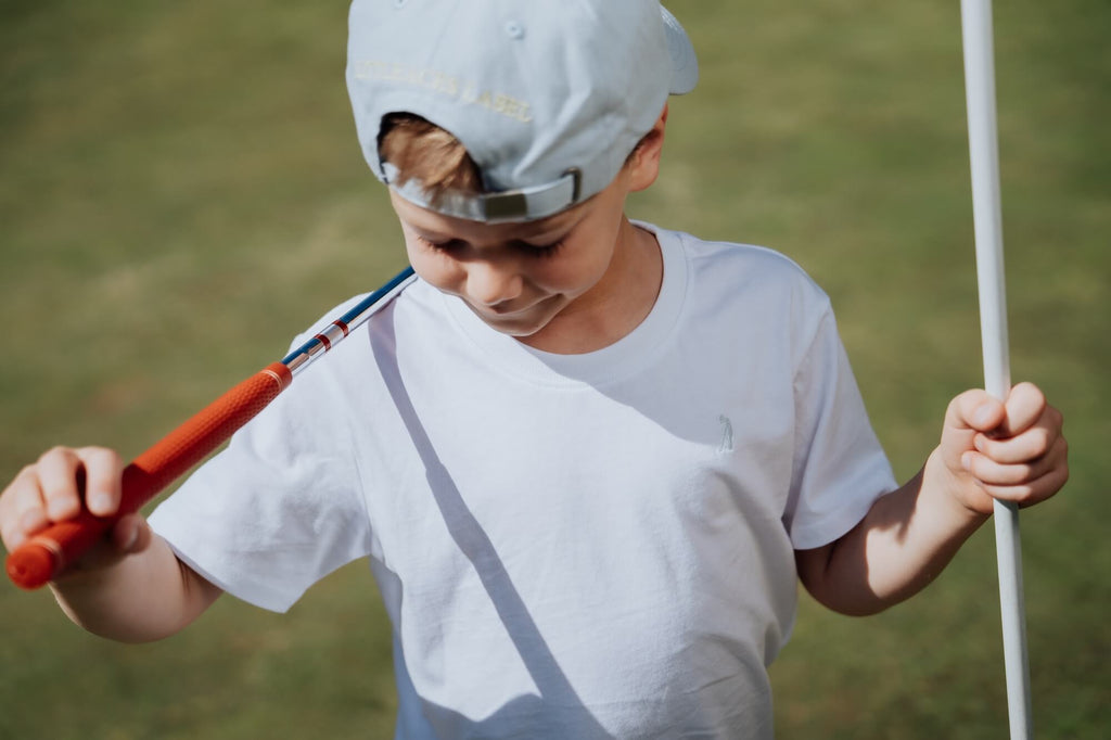 Child wearing white tee.
