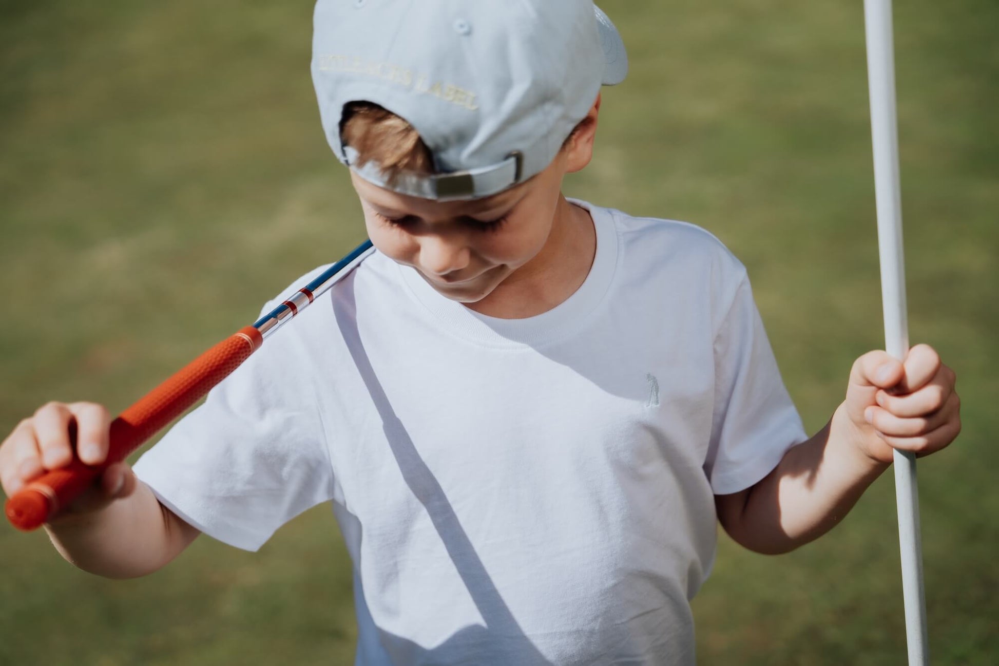 Child wearing white tee.